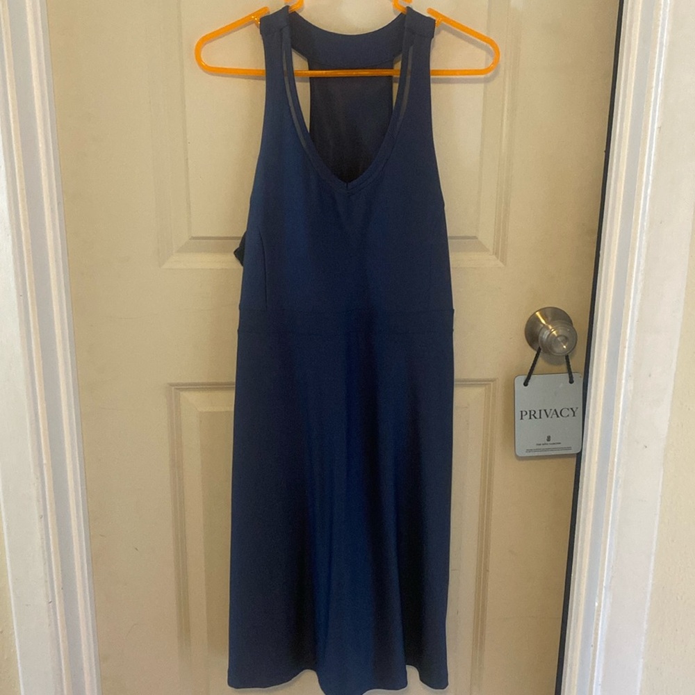 performance wear dress, stretchy, Athletic but dressy.  Built in bra cups